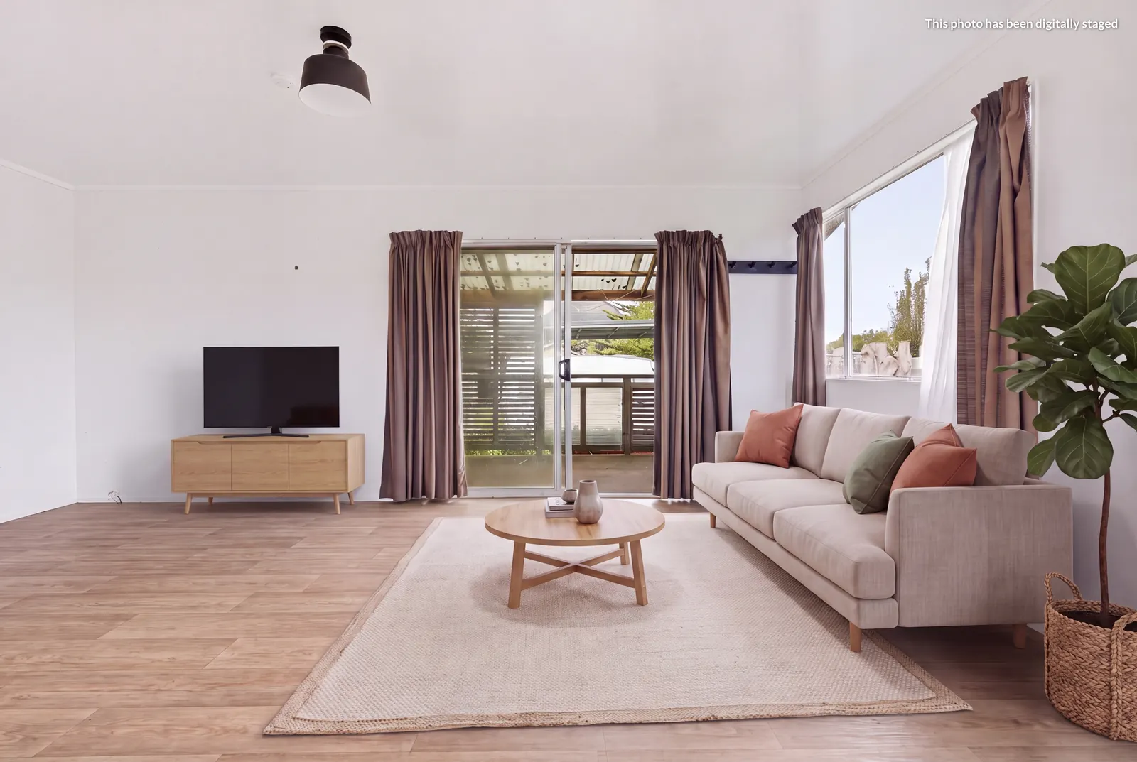 Virtually staged lounge at 76 Takahe Road, Ahipara, with the "This photo has been digitally staged" label in the top corner