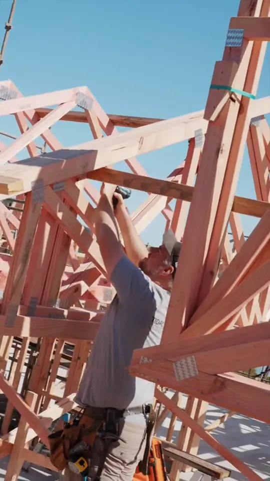 Tidal Construction crew framing roof trusses on site