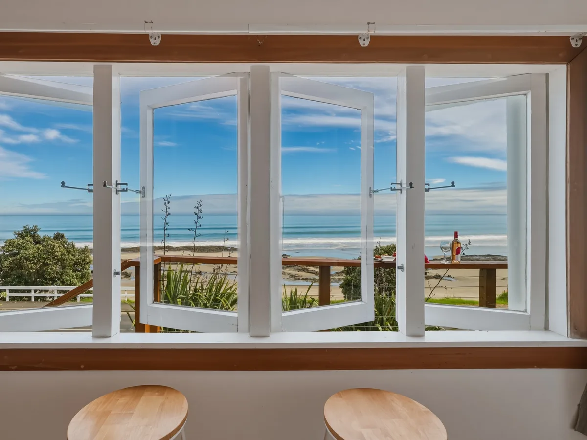 Beachfront outlook through the windows at 151 Foreshore Road, Ahipara